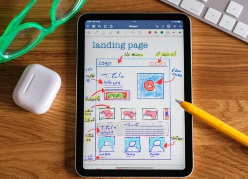 Close-up of tablet showing a hand-drawn landing page design, ideal for web development concepts.